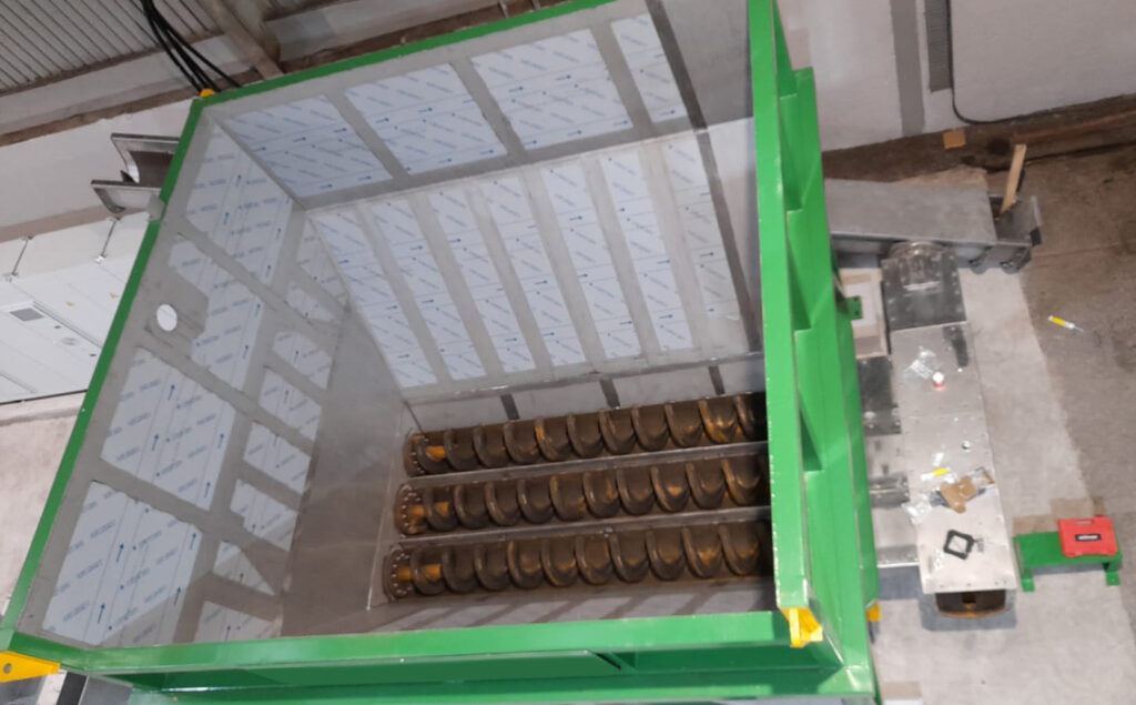 Spirotech manufactured recycling hopper with augers in base