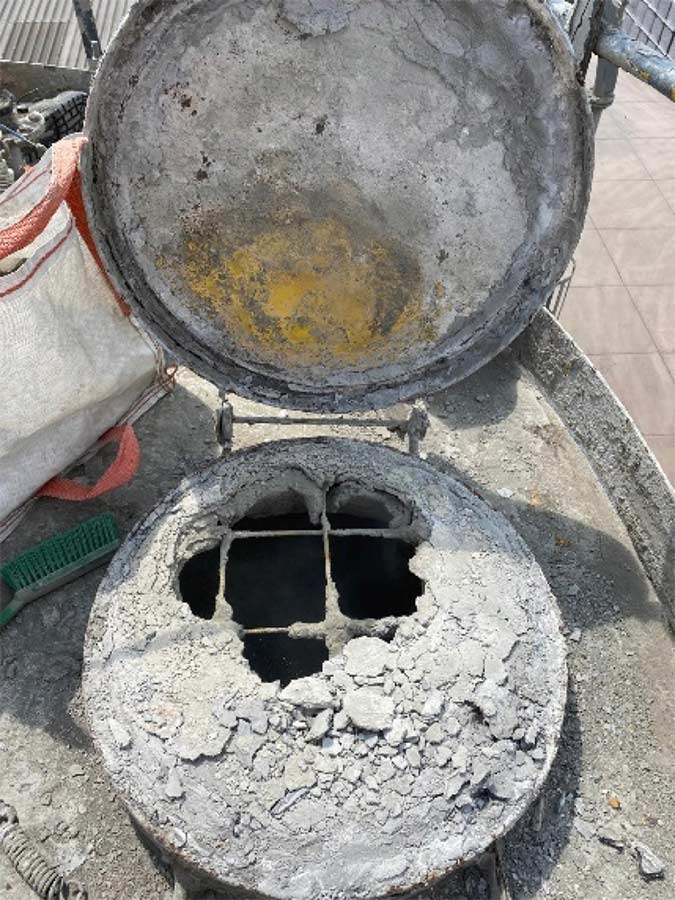 Before: Silo access hatch seal failed, moisture ingress present causing material build up.